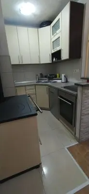 a small kitchen with white cabinets and a stove at Apartman Dijana in Livno