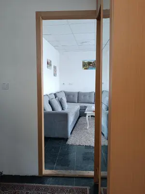 a living room with a couch and a mirror at Mountain Relax Vlašić in Vlasic