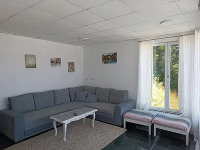 a living room with a couch and a table at Mountain Relax Vlašić in Vlasic