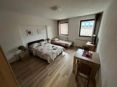 a bedroom with a bed and a table in it at stari grad in Doboj
