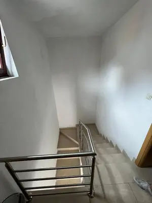 a staircase in an empty room with a metal railing at stari grad in Doboj