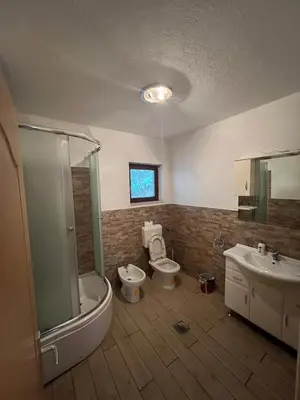 a bathroom with two toilets and a shower and a sink at stari grad in Doboj