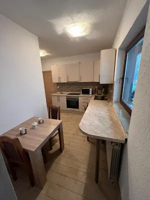 a kitchen with two wooden tables in a room at stari grad in Doboj