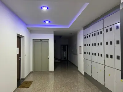 a hallway with white lockers and a blue ceiling at Apartman Sara in Zenica