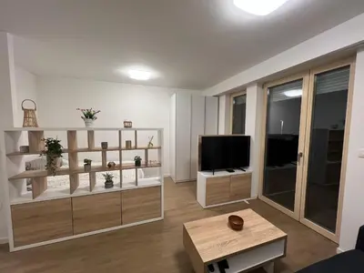 a living room with a television and a table at Apartman Sara in Zenica