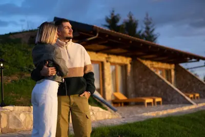 a man and a woman standing in front of a house at Zemunice Knezevic in Banja Luka