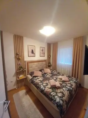 a bedroom with a large bed in a room at Apartman Jana in Doboj