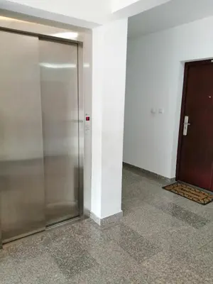 a elevator in a building with a glass door at Apartman Jana in Doboj