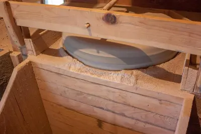a blue toilet sitting in a wooden box at Farm Stay Čardaklije in Kulen Vakuf
