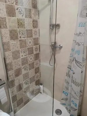 a bathroom with a shower with a glass door at APARTMAN KRPELJ Banja Luka in Budžak