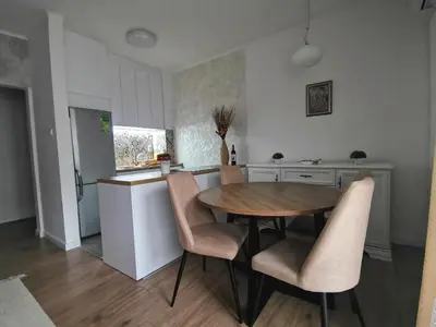 a kitchen with a table and chairs in a kitchen at APARTMAN KRPELJ Banja Luka in Budžak