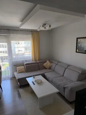 a living room with a couch and a coffee table at APARTMAN KRPELJ Banja Luka in Budžak