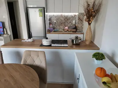a kitchen with a table with a bowl of fruit at APARTMAN KRPELJ Banja Luka in Budžak