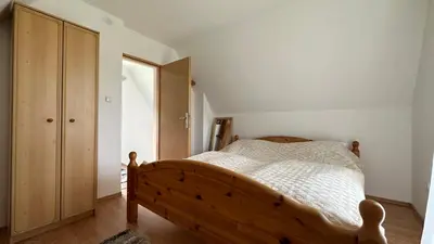 a bedroom with a wooden bed and a wooden cabinet at B&B Hills Bihać in Bihać