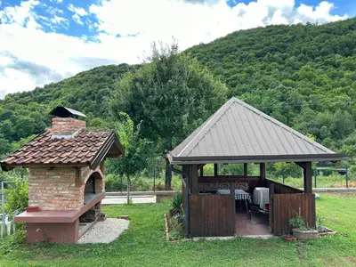a gazebo with a brick fireplace and a grill at B&B Hills Bihać in Bihać