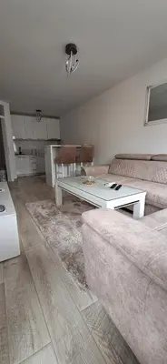 a living room with a couch and a table at Apartman-Centar-Bugojno in Bugojno