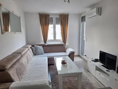 a living room with a couch and a table at Apartman-Centar-Bugojno in Bugojno