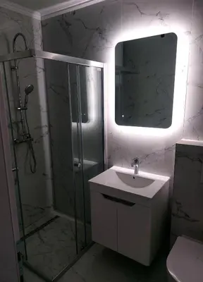 a bathroom with a shower and a sink and a mirror at Apartman-Centar-Bugojno in Bugojno