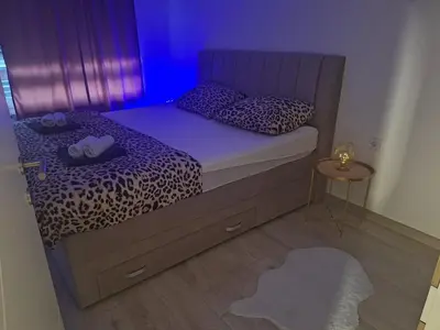 a bedroom with a bed with a leopard print at Apartman-Centar-Bugojno in Bugojno