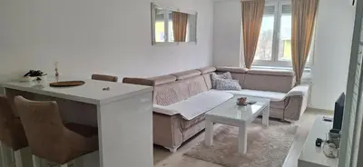 a living room with a couch and a table at Apartman-Centar-Bugojno in Bugojno