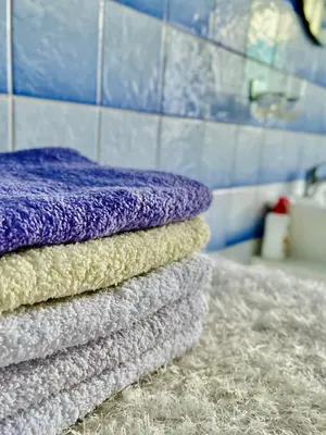 a stack of towels sitting on a counter in a bathroom at Kuća za odmor Bilić in Sopot