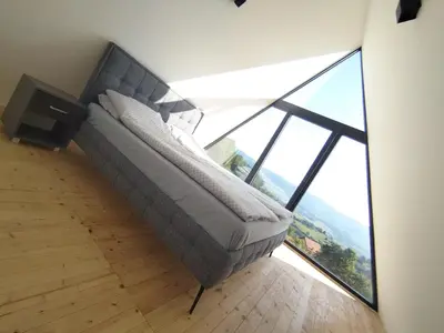 a bed in a room with a large window at Villa Vista in Banja Luka