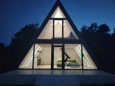 a triangular house with a living room in it at Villa Vista in Banja Luka