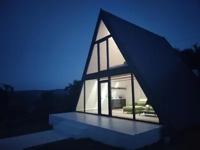 a house with a triangular roof with a couch at Villa Vista in Banja Luka