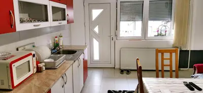 a kitchen with a sink and a microwave in it at Apartman Delic in Lukavac
