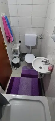 a small bathroom with a sink and a toilet at Apartman Delic in Lukavac