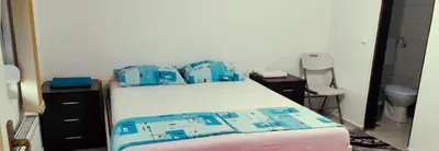 a bedroom with a bed with blue bags on it at Apartman Delic in Lukavac