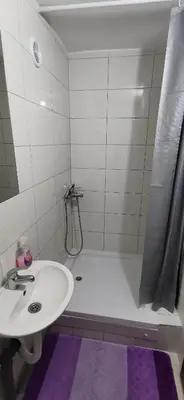 a bathroom with a sink and a shower and a tub at Apartman Delic in Lukavac
