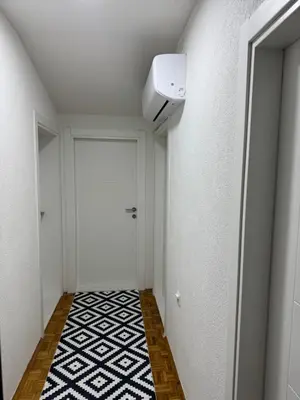 a hallway with a door and a white wall at Apartment Star in Jajce