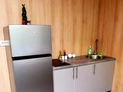 a kitchen with a refrigerator and a sink at Apartman Košuta in Laktaši