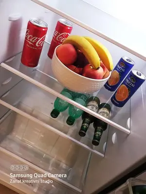 an open refrigerator with a bowl of fruit and drinks at Apartman Košuta in Laktaši