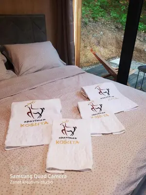 a table with towels on top of a bed at Apartman Košuta in Laktaši