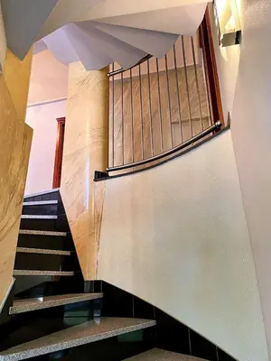 a spiral staircase in a building with a window at Deutsches Haus Livno in Livno