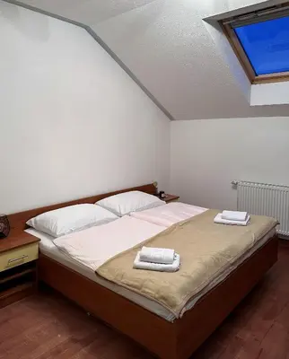 a bedroom with a bed with two towels on it at Deutsches Haus Livno in Livno
