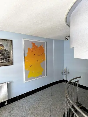 a room with a blue wall with a painting on it at Deutsches Haus Livno in Livno