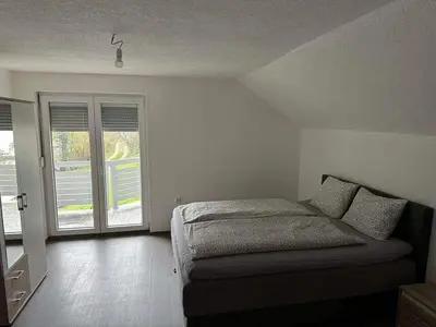 a bedroom with a bed and a large window at Villa ADA in Jajce