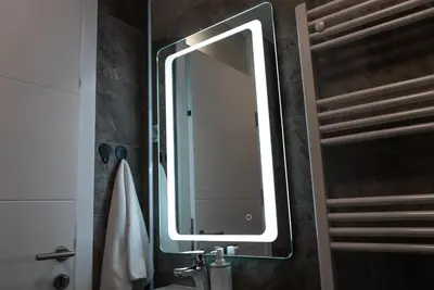 a bathroom with a large mirror and a sink at Lux Apartment III Prijedor in Prijedor