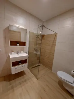 a bathroom with a shower and a sink and a toilet at Apartman Centar Kozarska Dubica in Bosanska Dubica