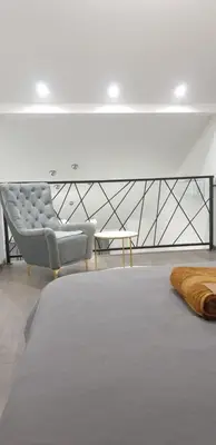 a living room with a couch and a chair at Central Maisonette in Banja Luka