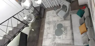 an overhead view of a living room with a staircase at Central Maisonette in Banja Luka