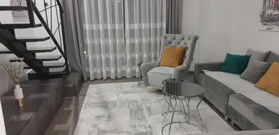 a living room with a couch and a chair at Central Maisonette in Banja Luka