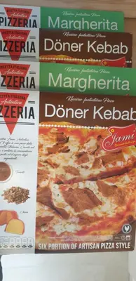 a bunch of pizza signs on a wall at Central Maisonette in Banja Luka