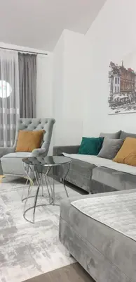 a living room with a couch and a table at Central Maisonette in Banja Luka