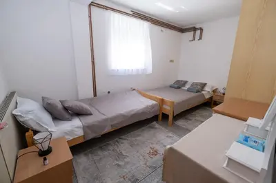a room with two beds and a window at GOOD People in Bihać