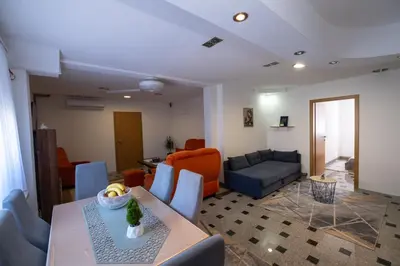 a living room with a table and a couch at GOOD People in Bihać