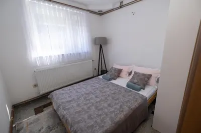 a bedroom with a bed in a room with a window at GOOD People in Bihać